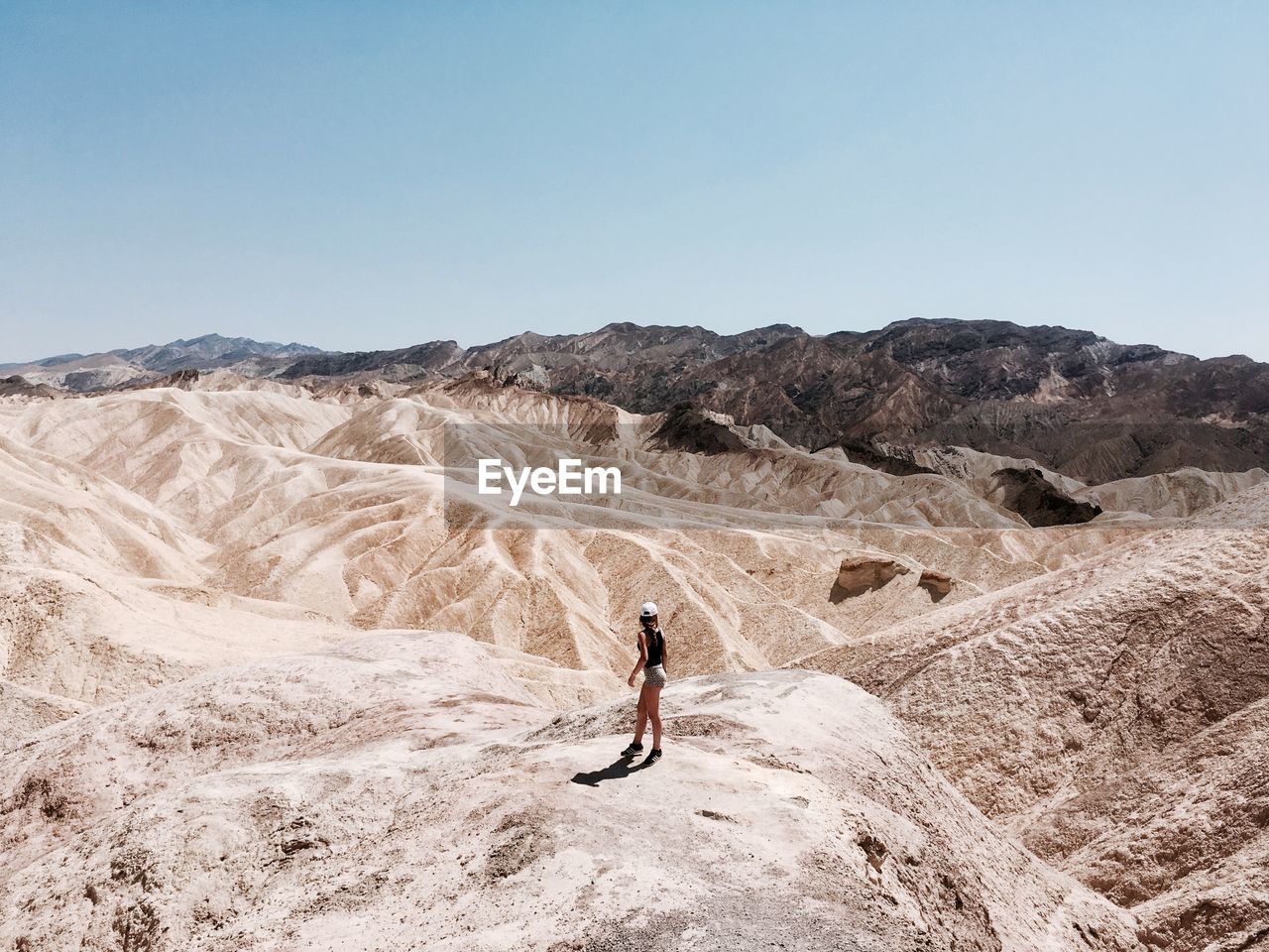 Full length of woman on arid landscape against sky