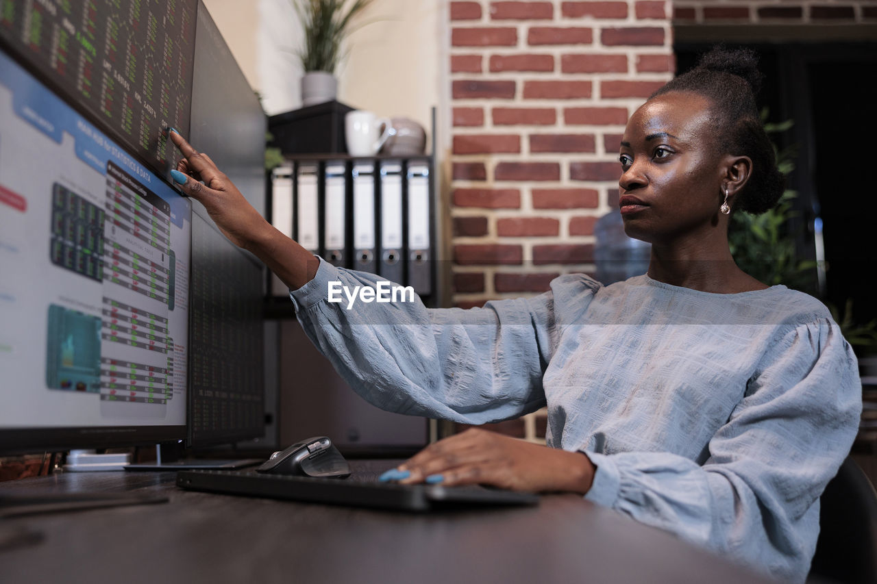 side view of young man working at desk in office