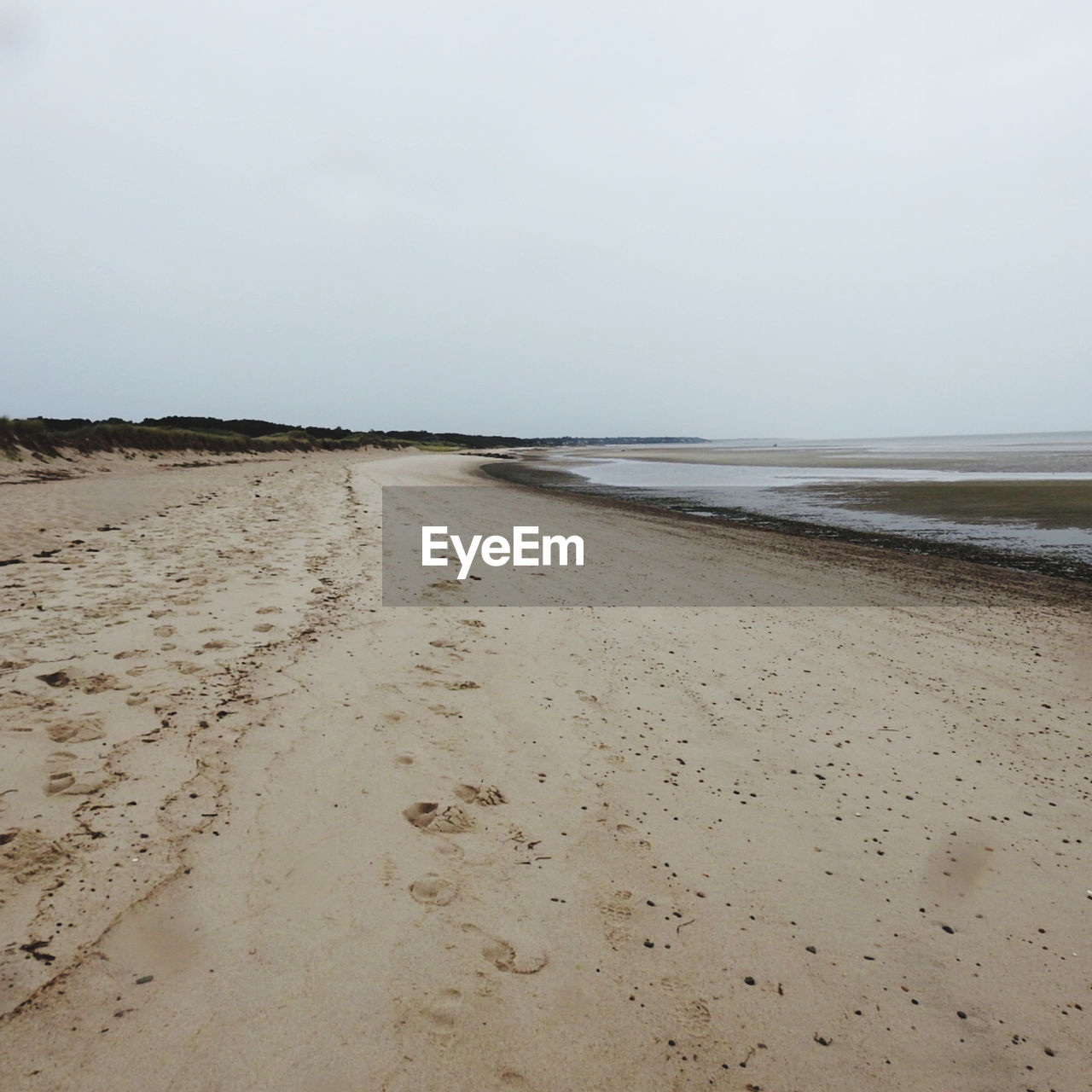 SCENIC VIEW OF SANDY BEACH AGAINST CLEAR SKY AGAINST THE BACKGROUND