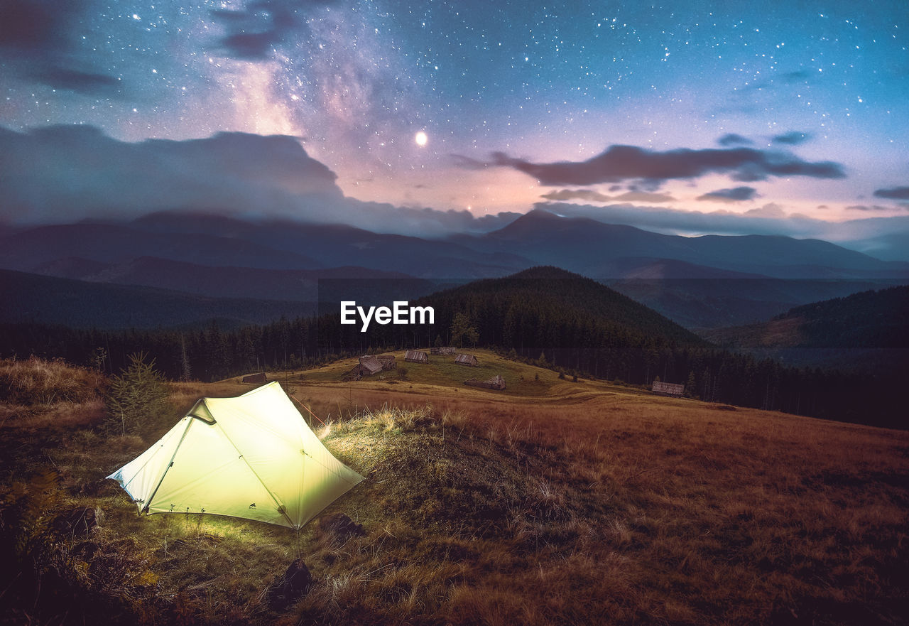 Scenic view of field against sky at night