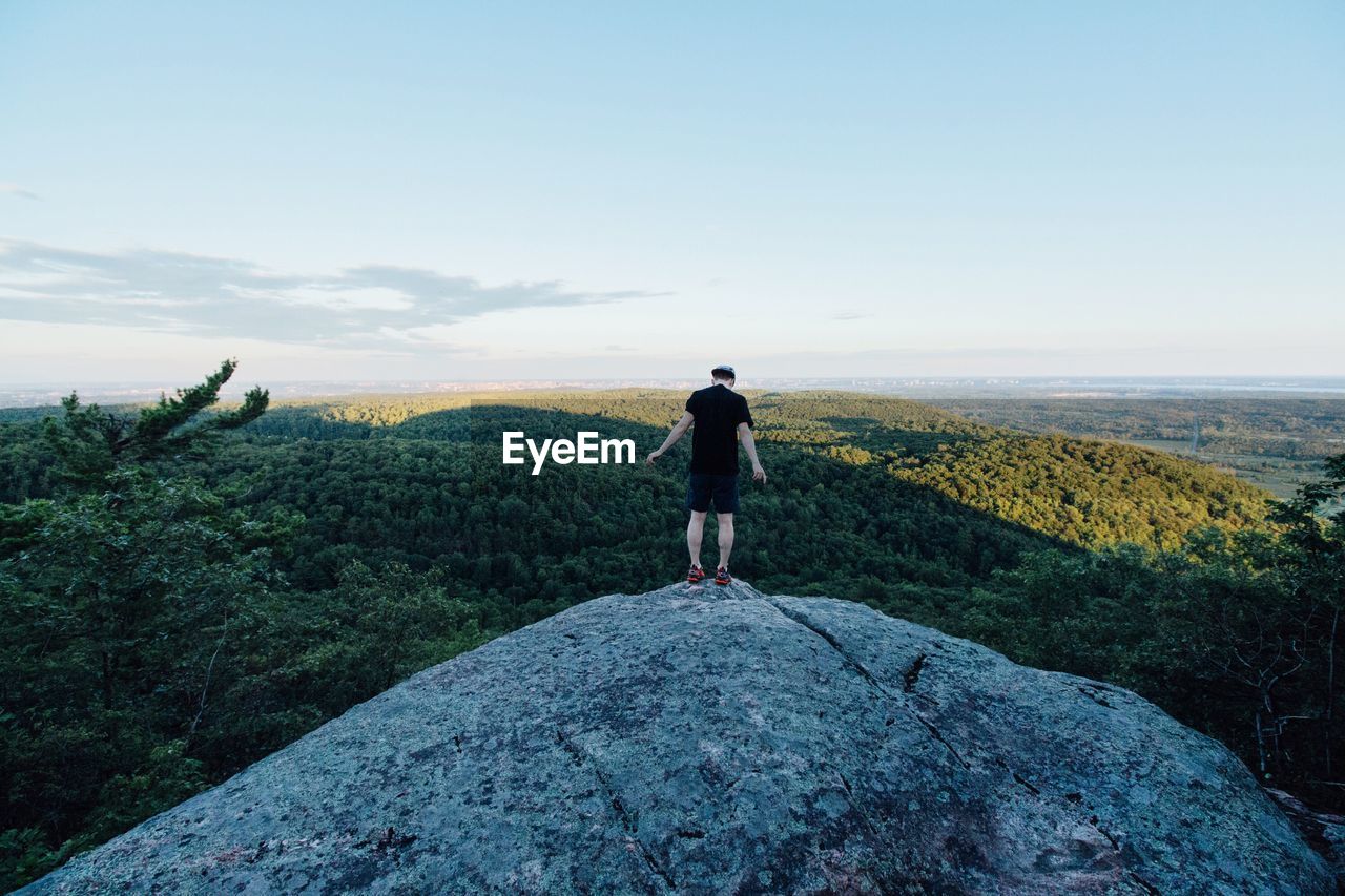 Rear view of man standing on mountain