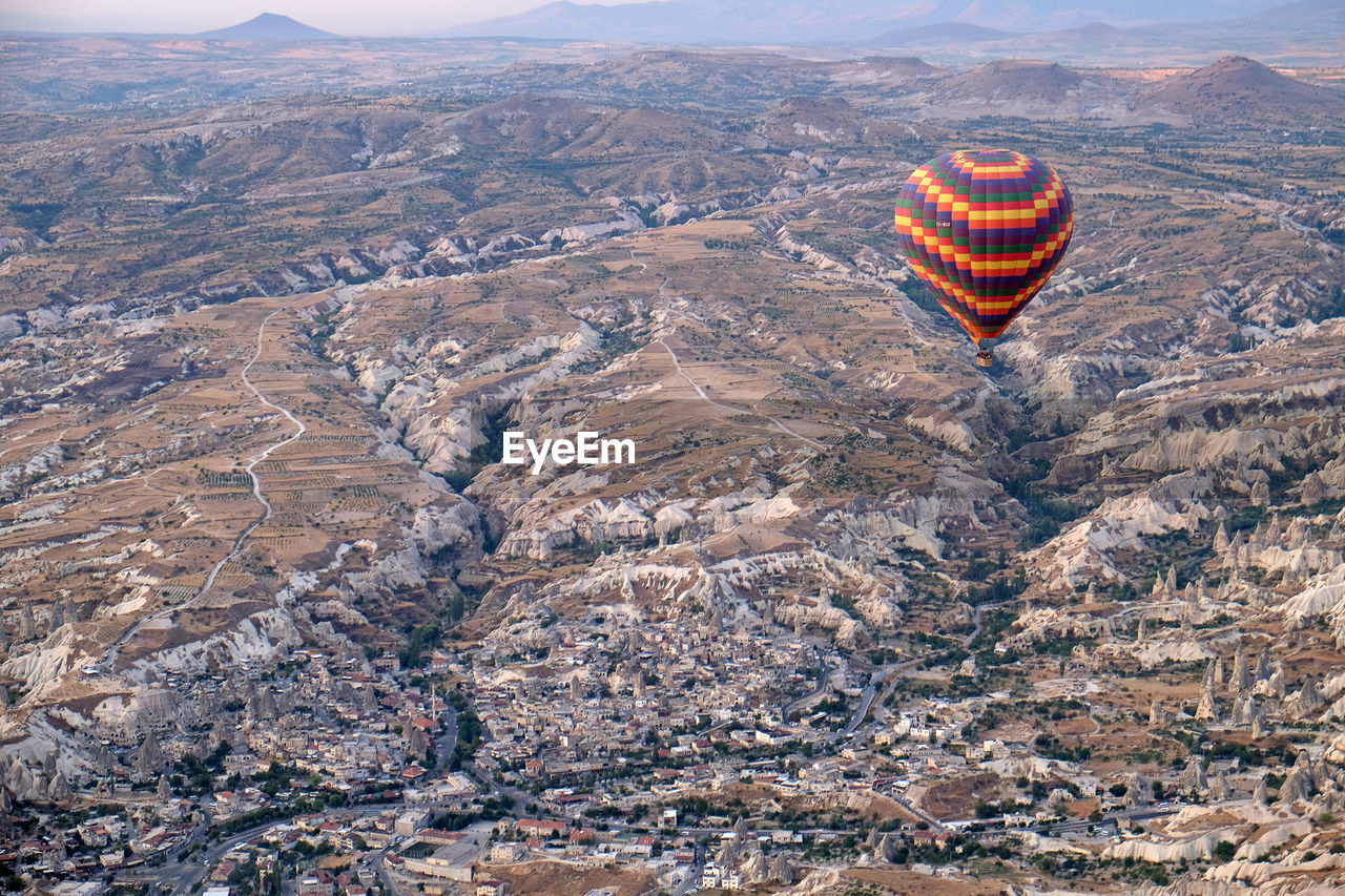 Aerial view of hot air balloon flying over rocks, turkey