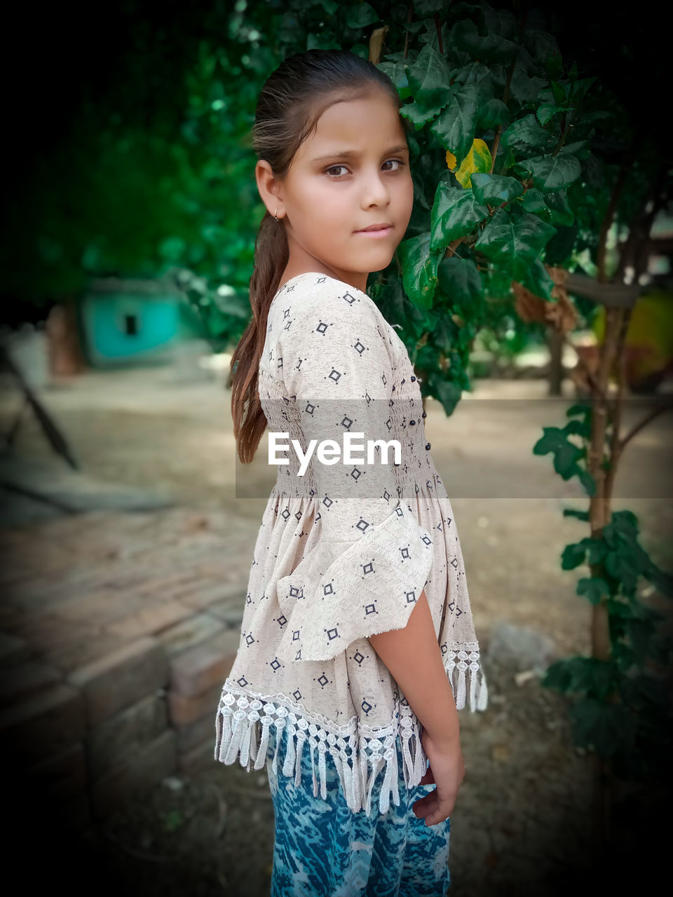 Portrait of smiling girl standing outdoors