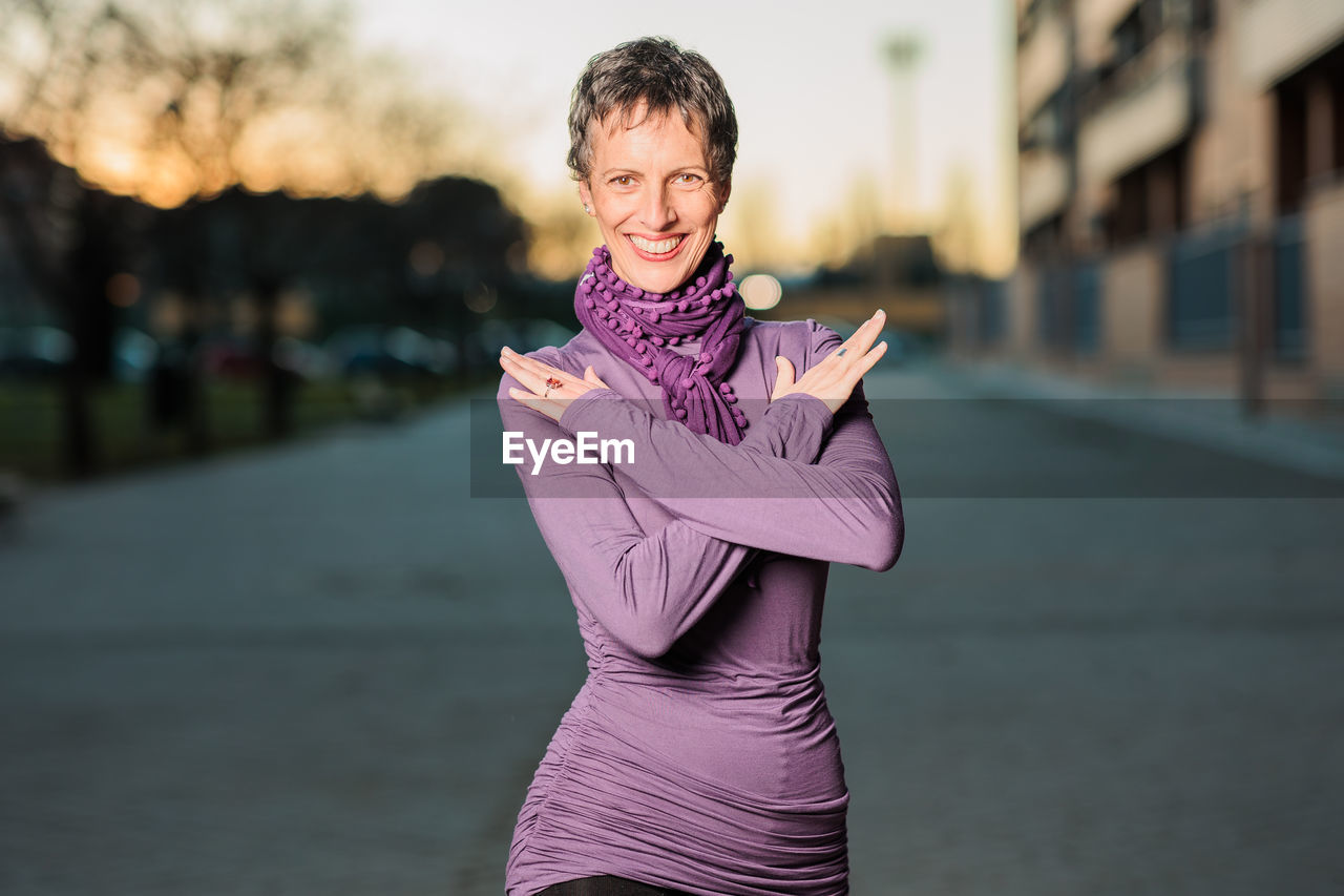 Portrait of smiling woman standing outdoors