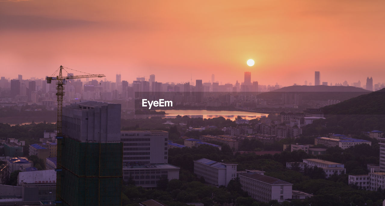 Cityscape against sky during sunset