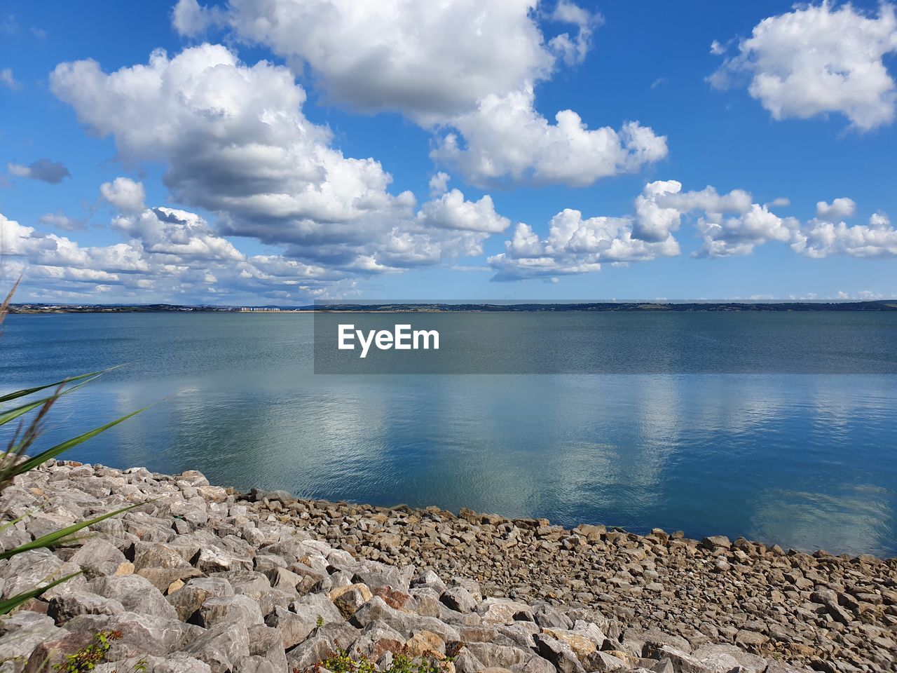 SCENIC VIEW OF SEA BY ROCKS AGAINST SKY