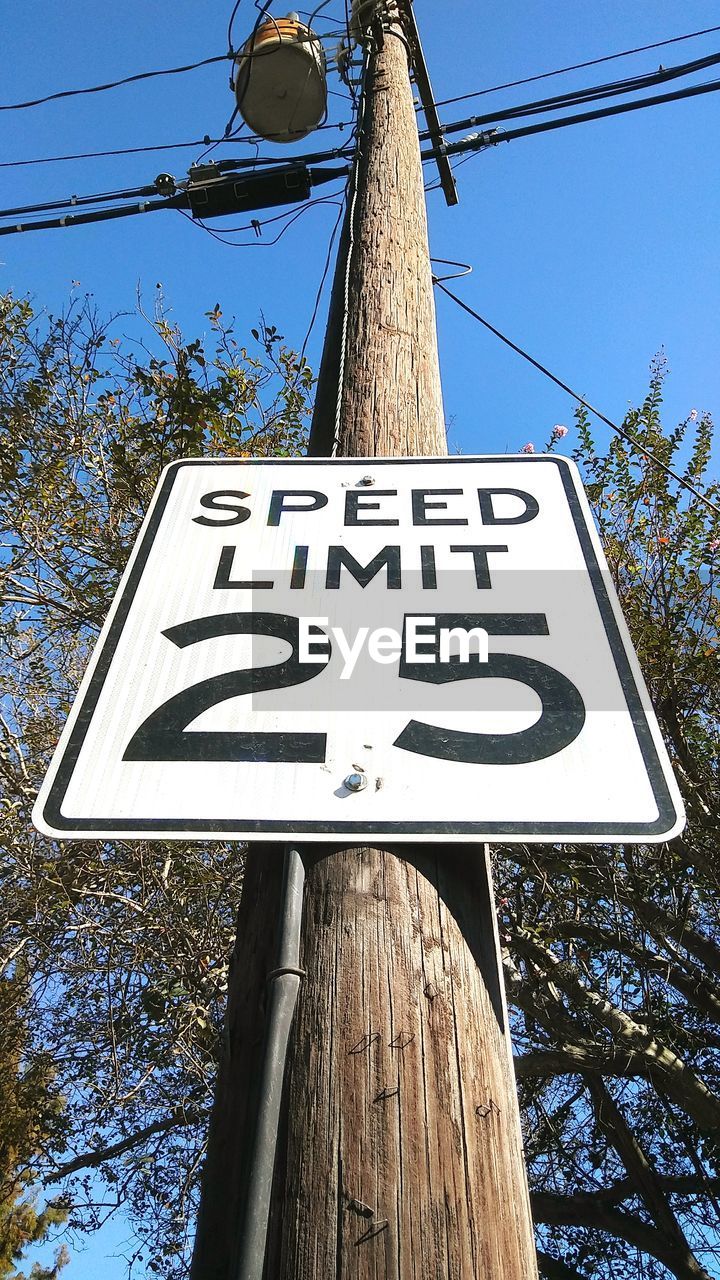 Low angle view of road sign against sky