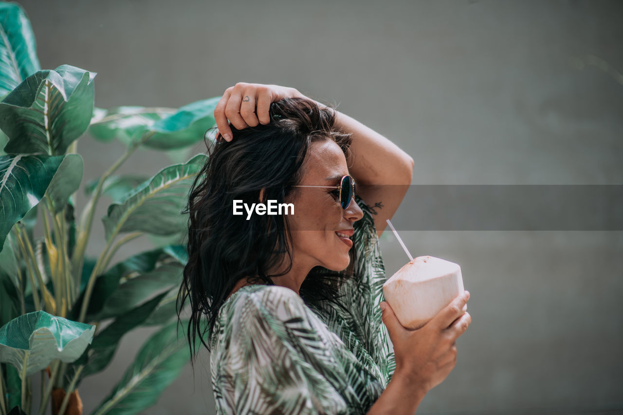 Portrait of young woman drinking water