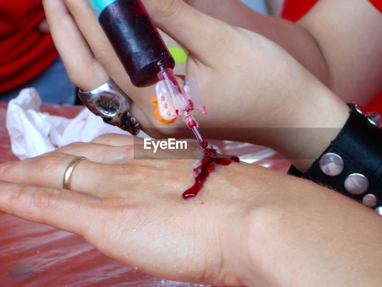 Close-up of woman getting artificial blood make-up