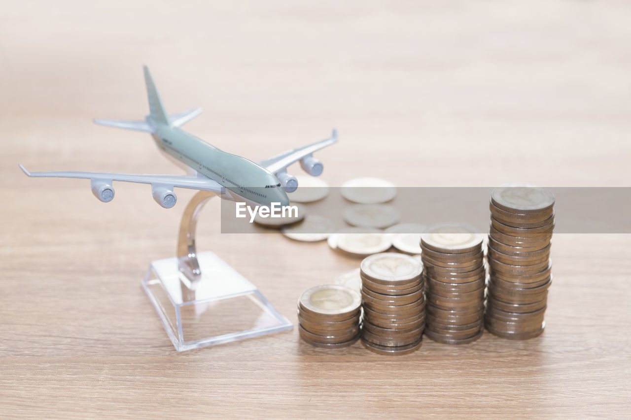 Close-up of coins and model airplane on table