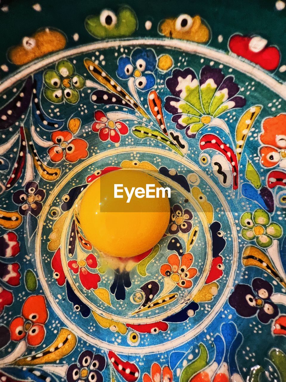 Egg yolk in colorful bowl