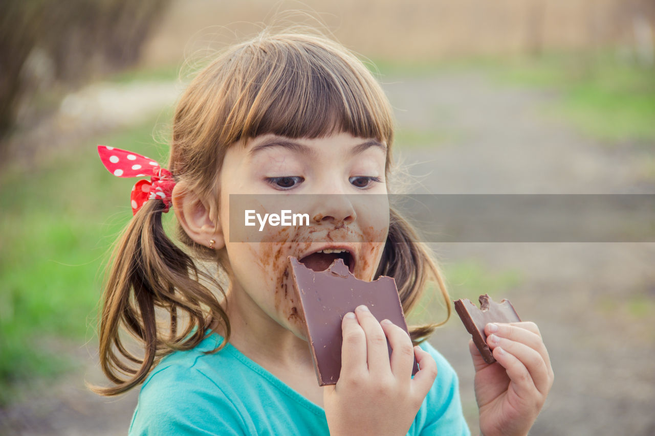 close-up portrait of young woman holding ice cream