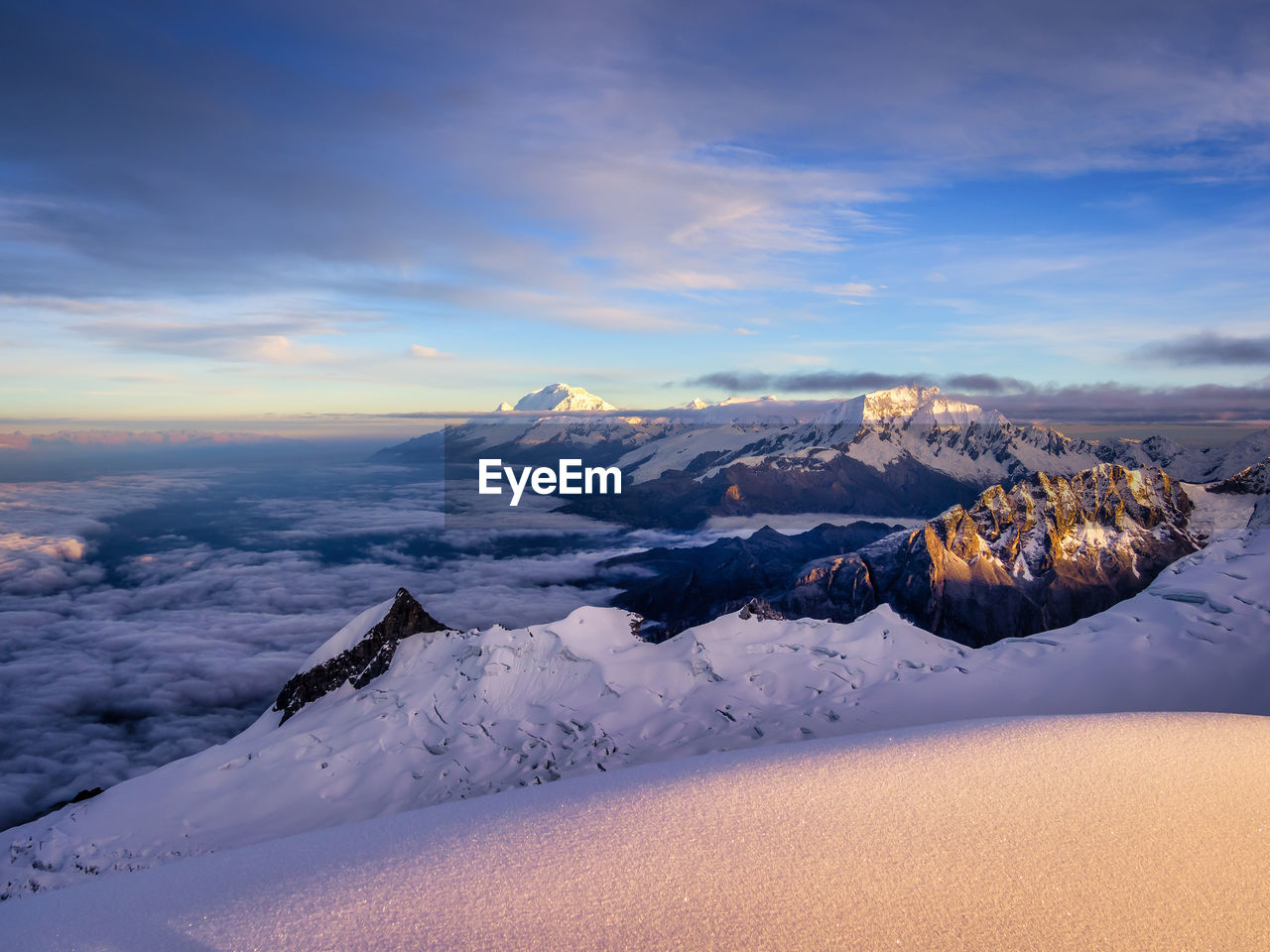 SNOWCAPPED MOUNTAINS AGAINST SKY DURING SUNSET