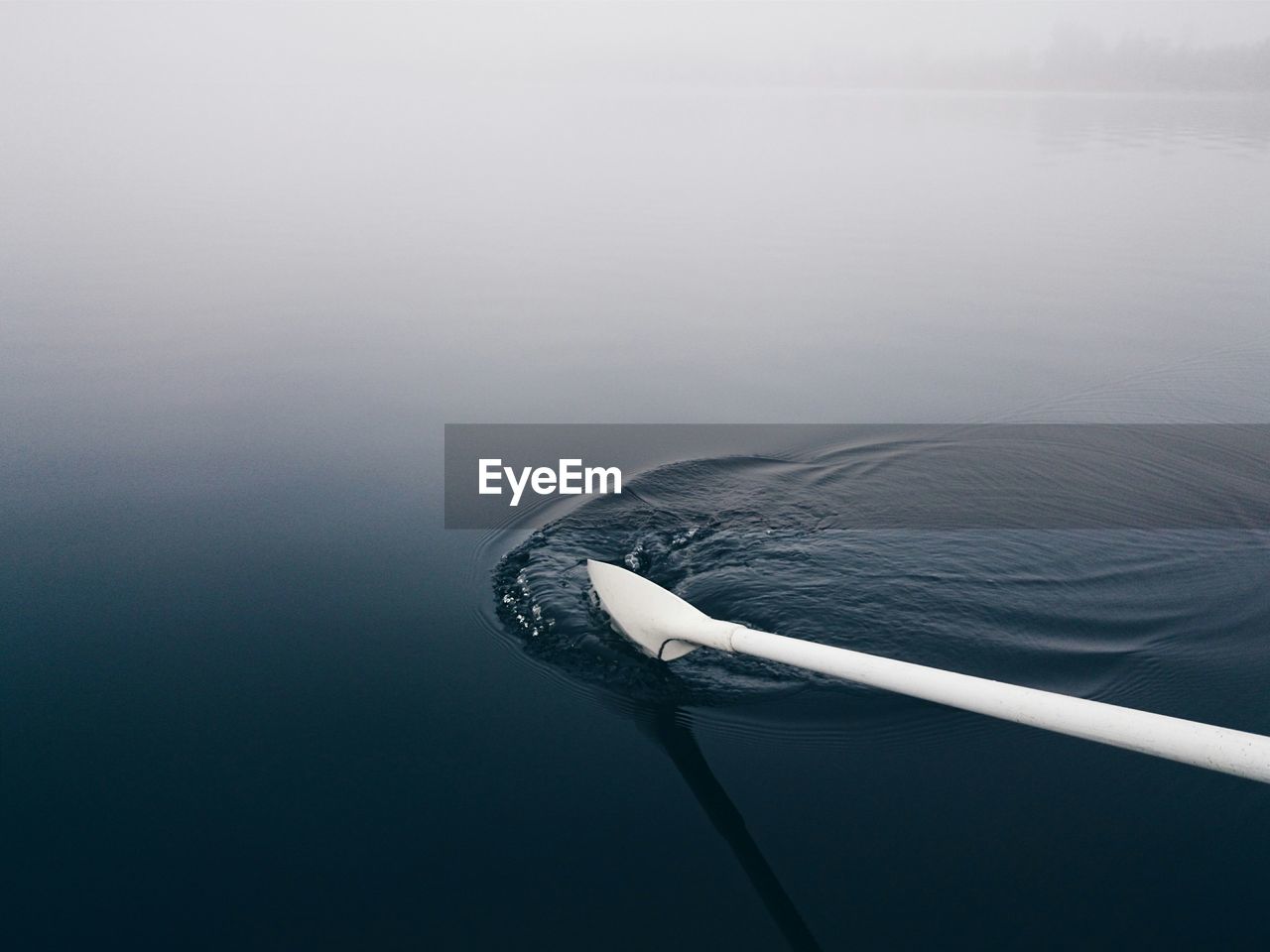 Cropped image of white oar in lake