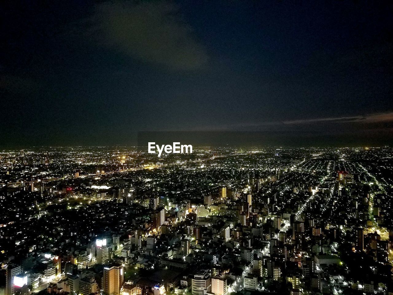 AERIAL VIEW OF ILLUMINATED CITYSCAPE