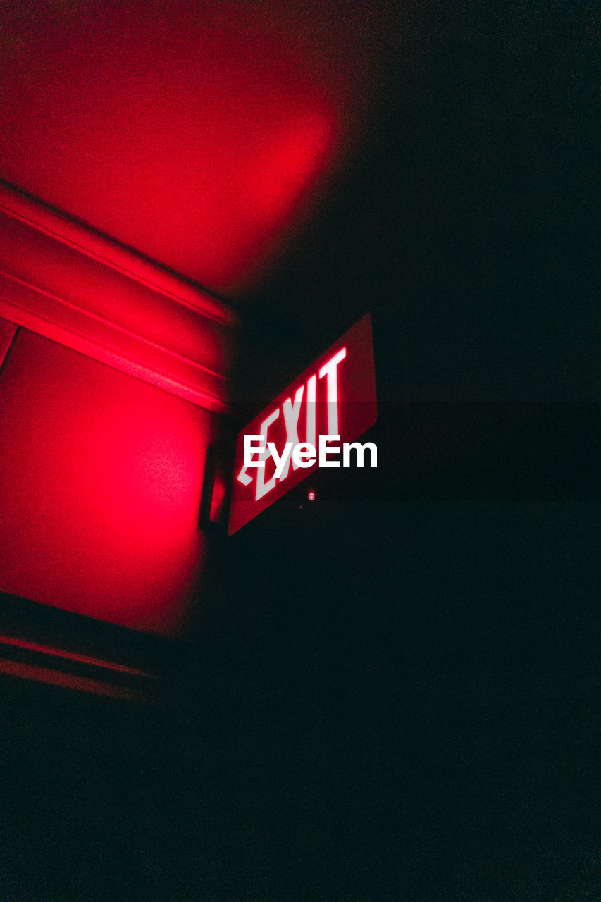 red, light, text, communication, illuminated, sign, western script, darkness, no people, lighting, night, signage, neon, indoors, guidance, exit sign, low angle view, lighting equipment, wall - building feature, font, black, neon sign, white, line