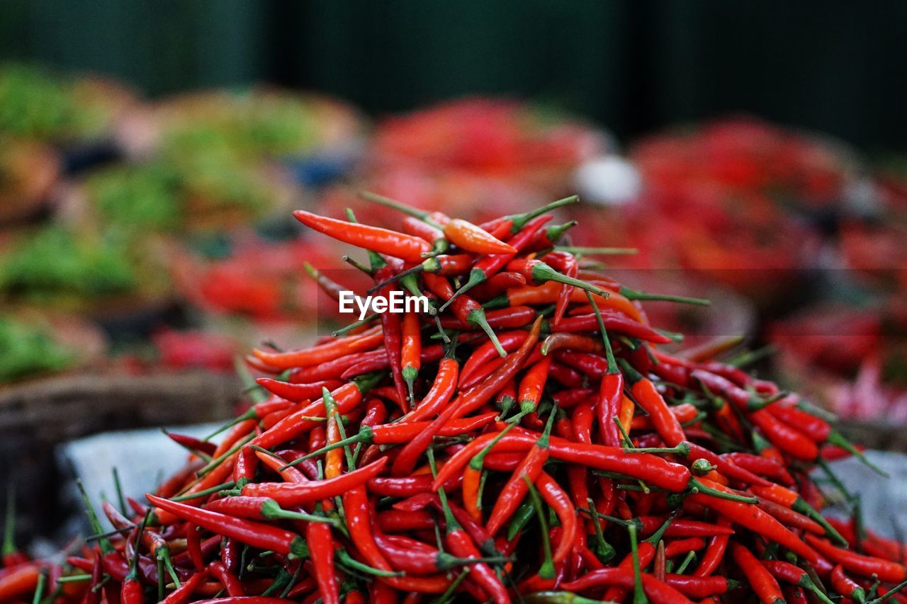 CLOSE-UP OF RED CHILI PEPPER FOR SALE AT MARKET STALL