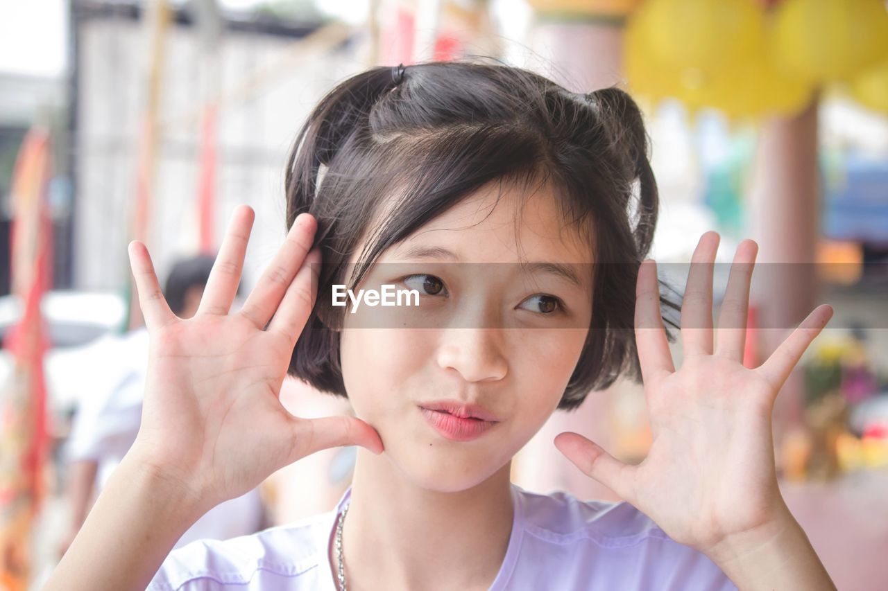 Portrait of cute girl smile with hand and innocent in the countryside