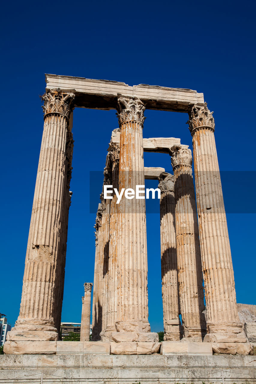 Ruins of the temple of olympian zeus also known as the olympieion and the acropolis in athens 