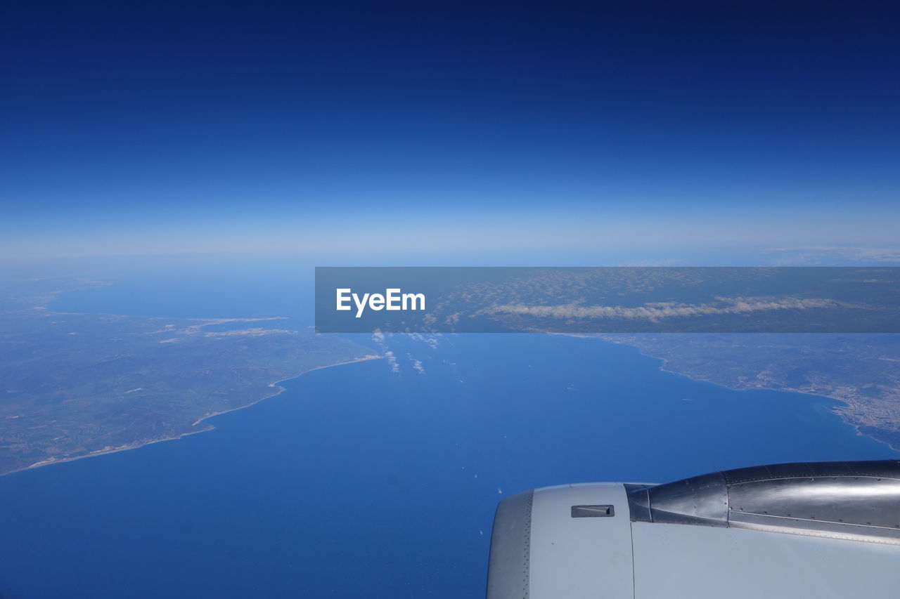 Aerial view of sea against blue sky