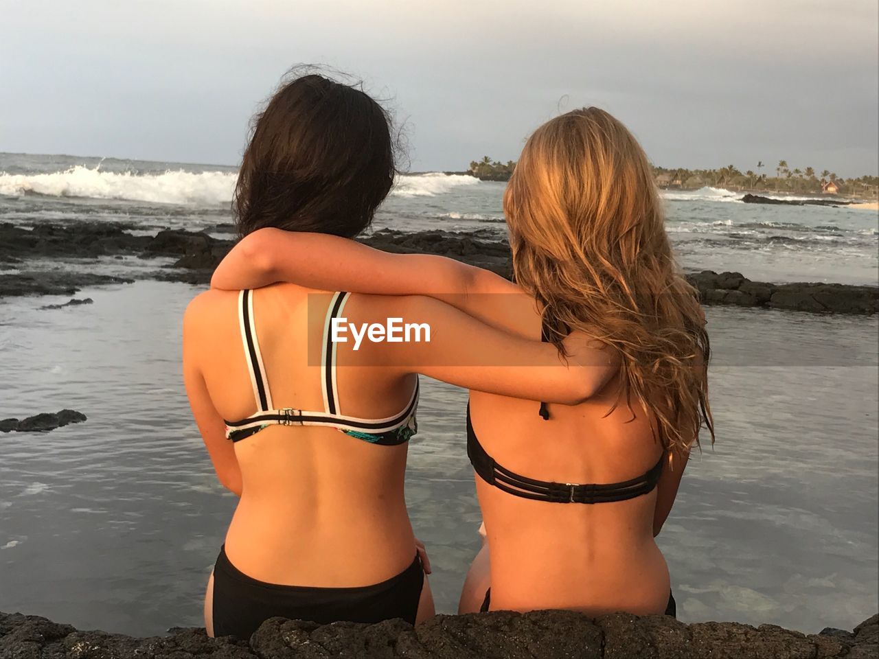 Rear view of female friends at beach