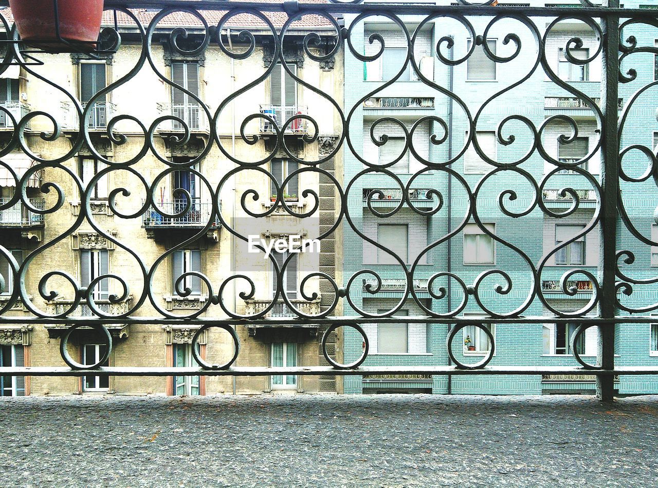 Residential buildings seen through balcony railing