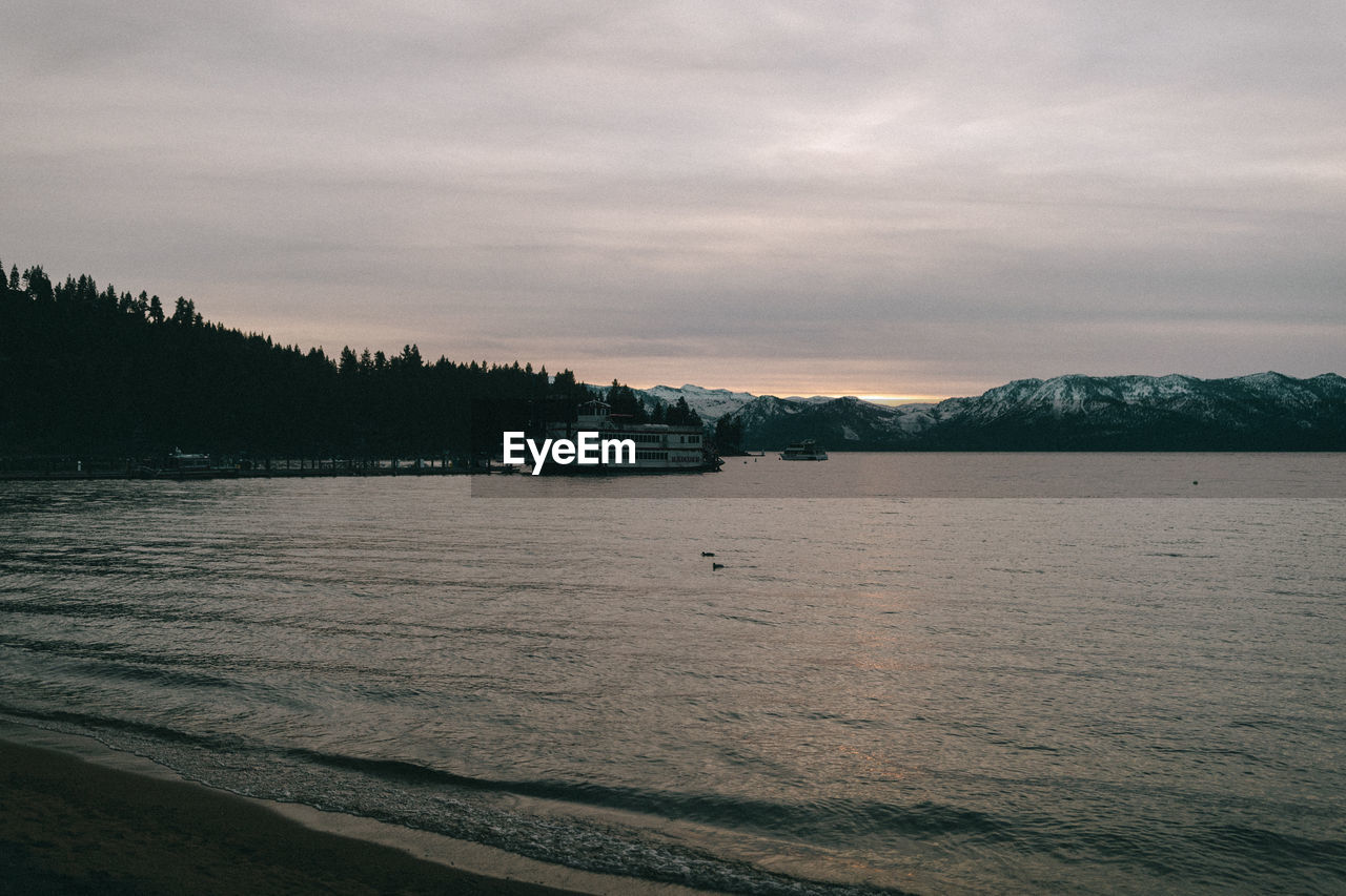 PANORAMIC SHOT OF SEA AGAINST SKY AT DUSK