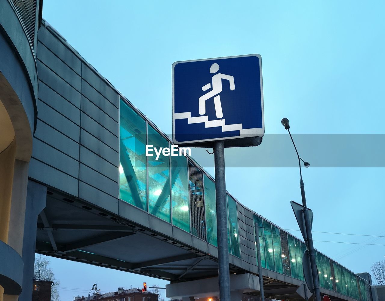 LOW ANGLE VIEW OF SIGNBOARD AGAINST BLUE SKY