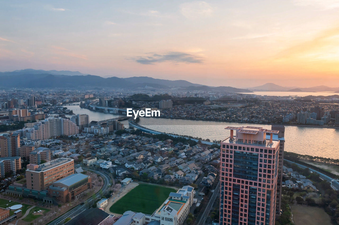 Skyline cityscape view from fukuoka tower at sunset golden hour, kyshu, japan. downtown landscape