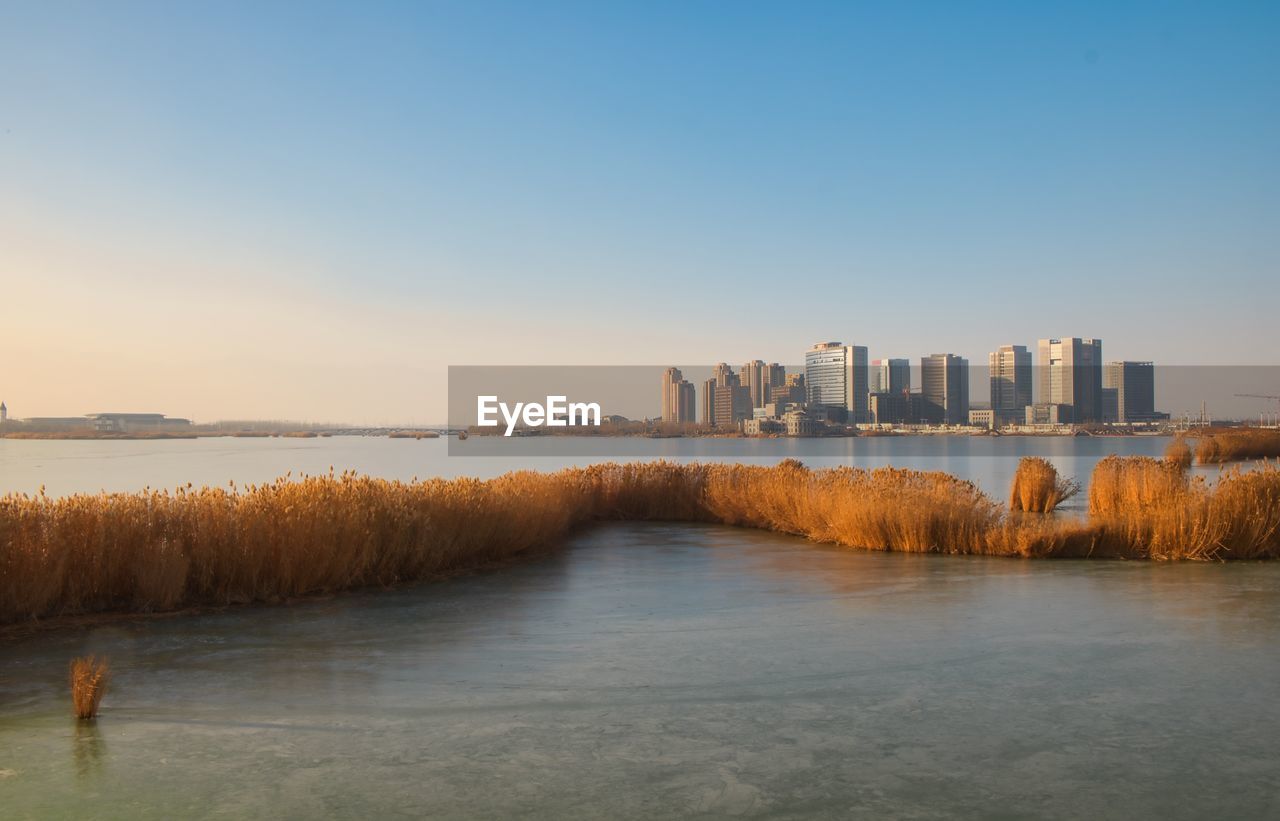 Yinchuan new commercial district over frozen chenjia lake.