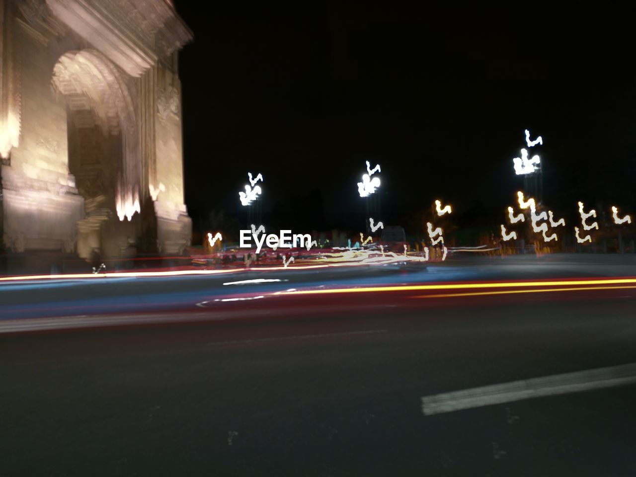 LIGHT TRAILS ON ROAD IN CITY