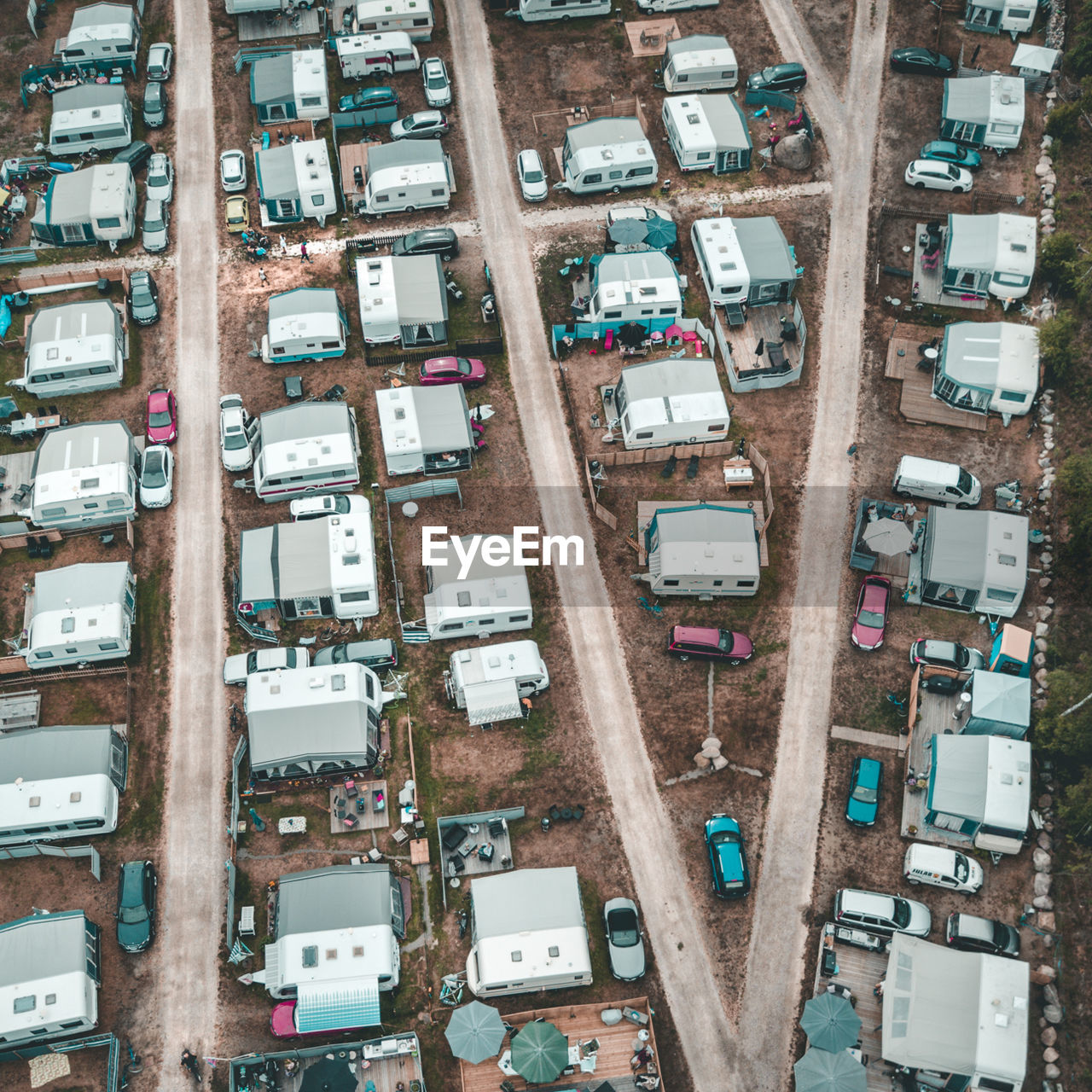 Aerial view of caravans and cars parked on road