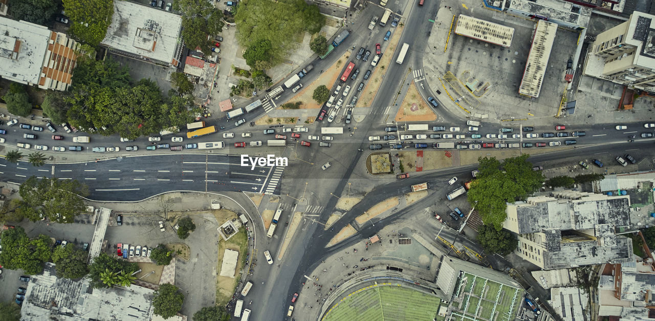 Road traffic on crossroad or intersection downtown of latin american city, aerial or top view