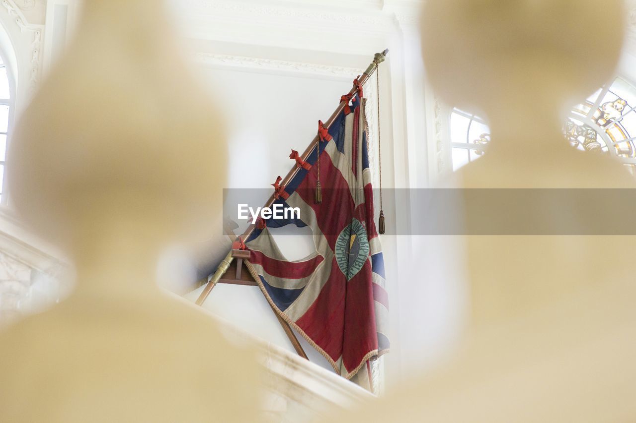 selective focus, indoors, focus on background, hanging, no people, musical instrument, day, close-up