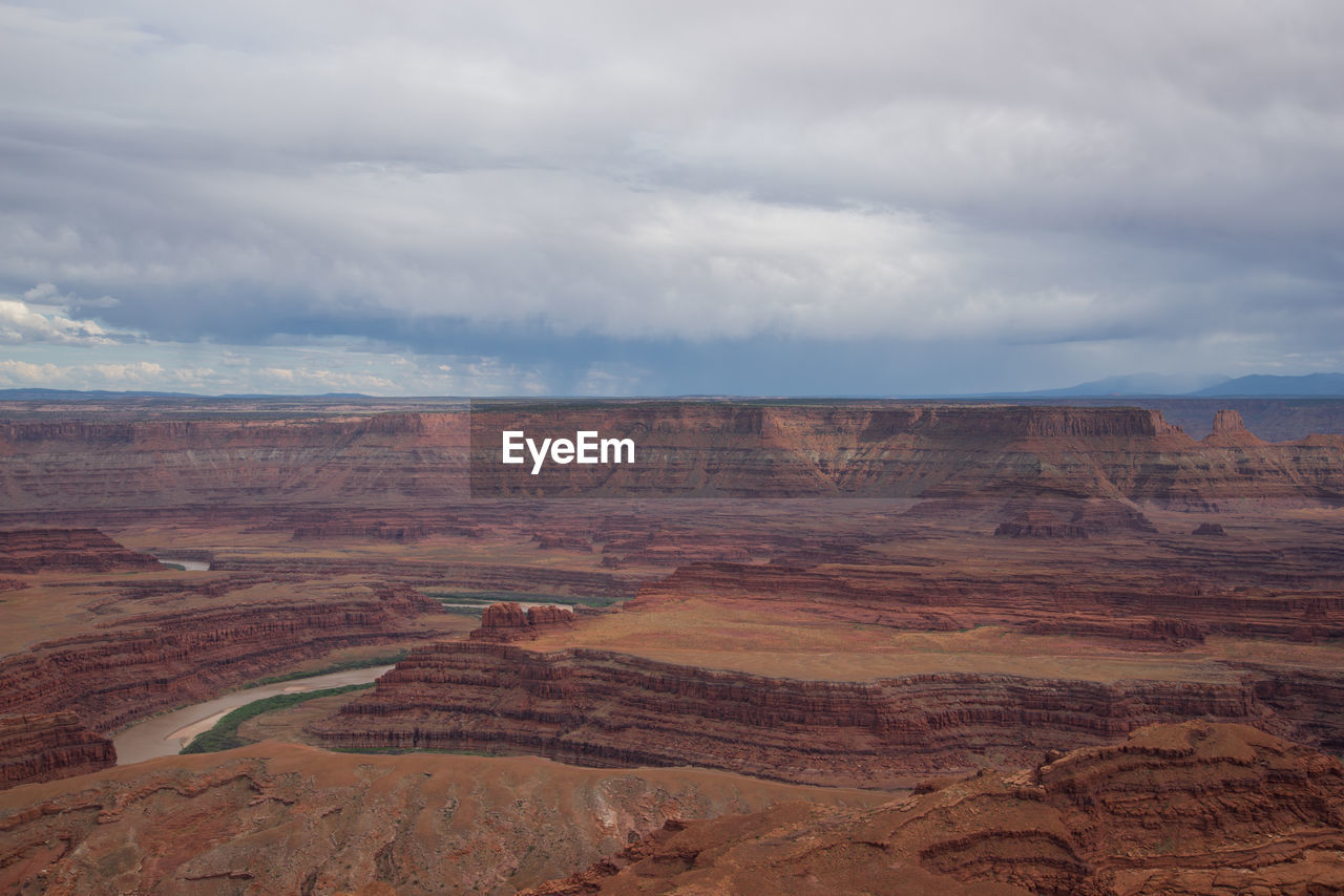 Scenic view of dramatic landscape against cloudy sky