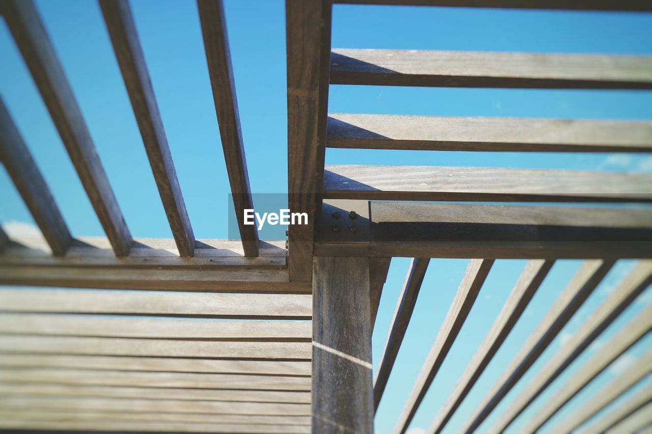 Close-up of wooden structure against sky