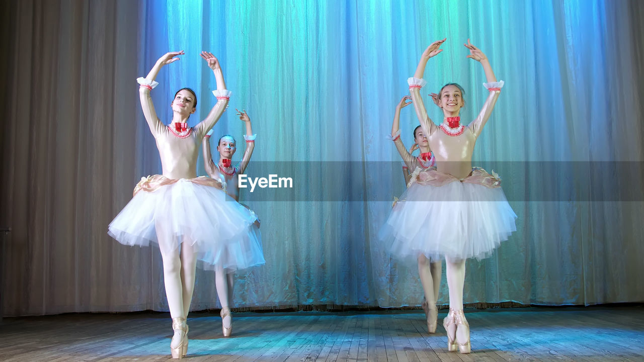 Ballet rehearsal, on the stage of the old theater hall. young ballerinas in elegant dresses