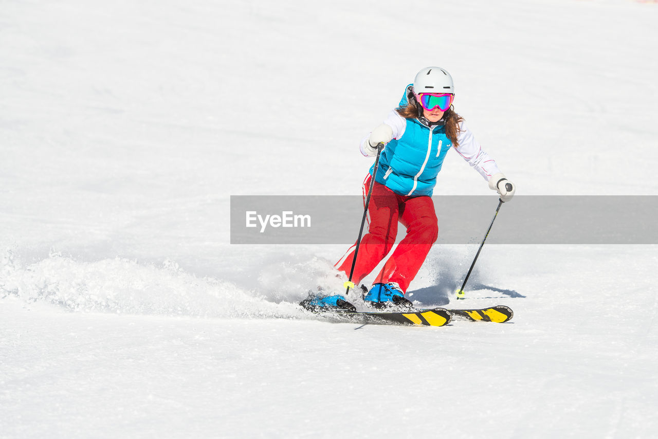 Full length of woman skiing on snow