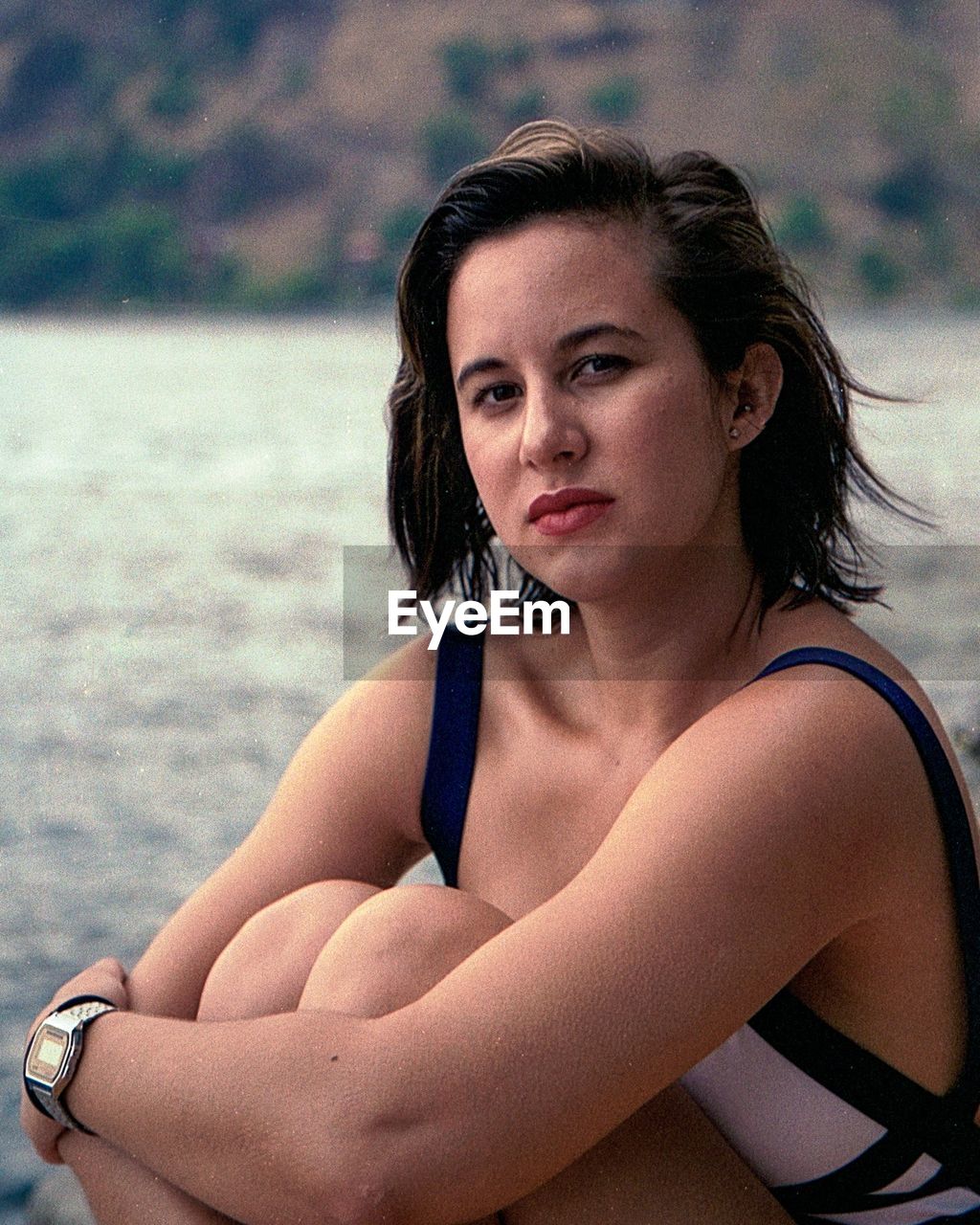 Portrait of beautiful young woman sitting at beach