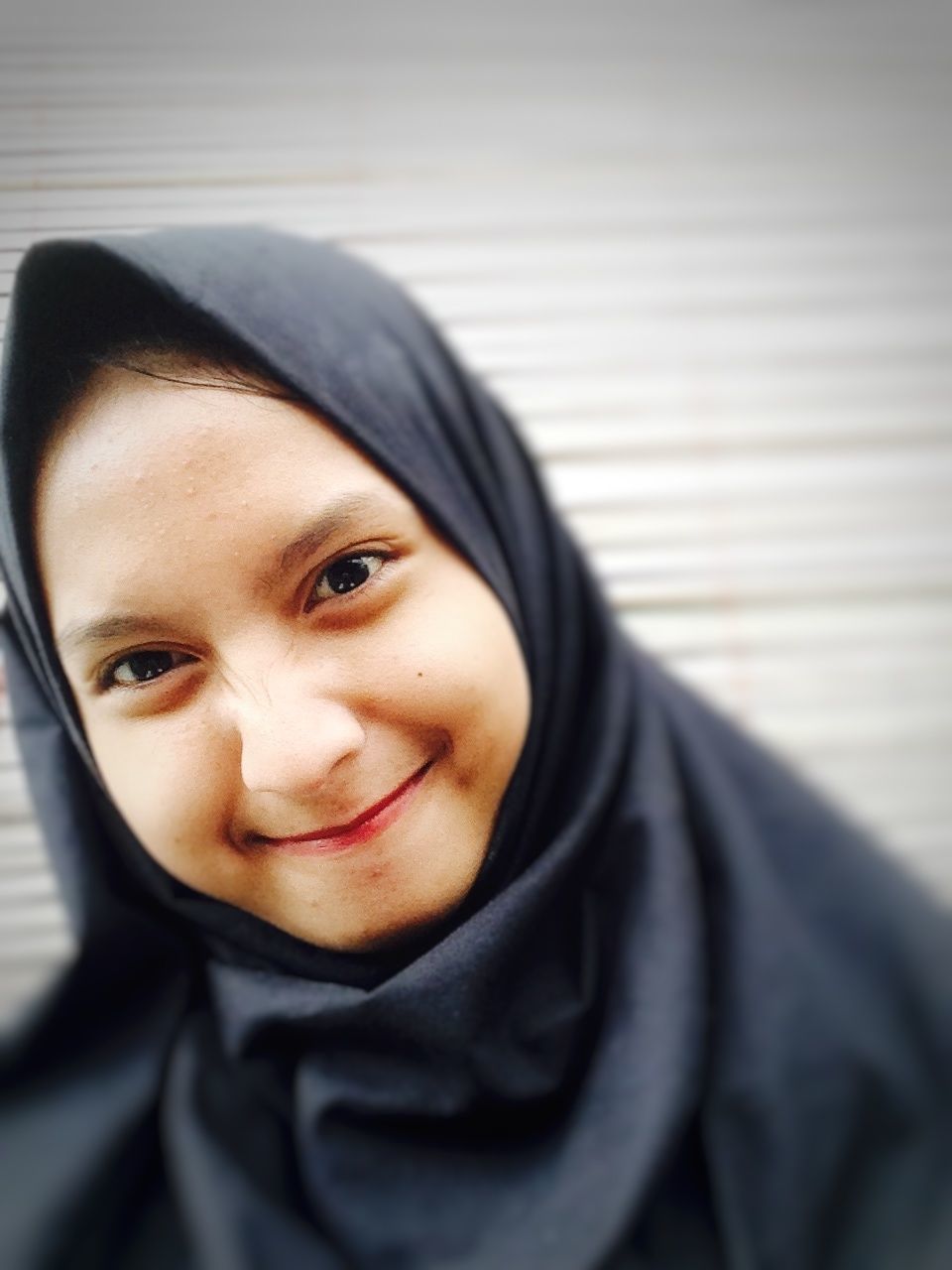 Portrait of happy woman in hijab
