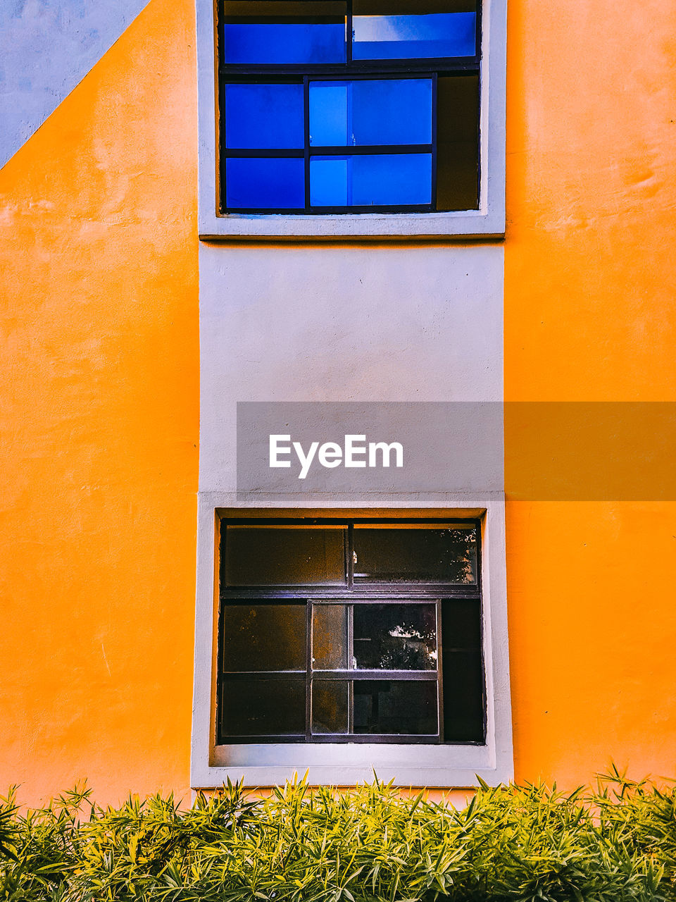 LOW ANGLE VIEW OF YELLOW BUILDING