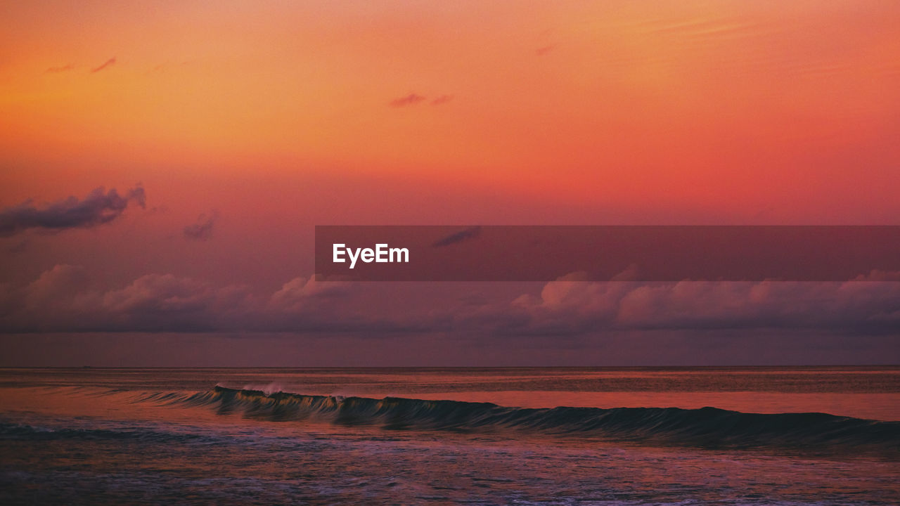 Scenic view of sea against romantic sky at sunset