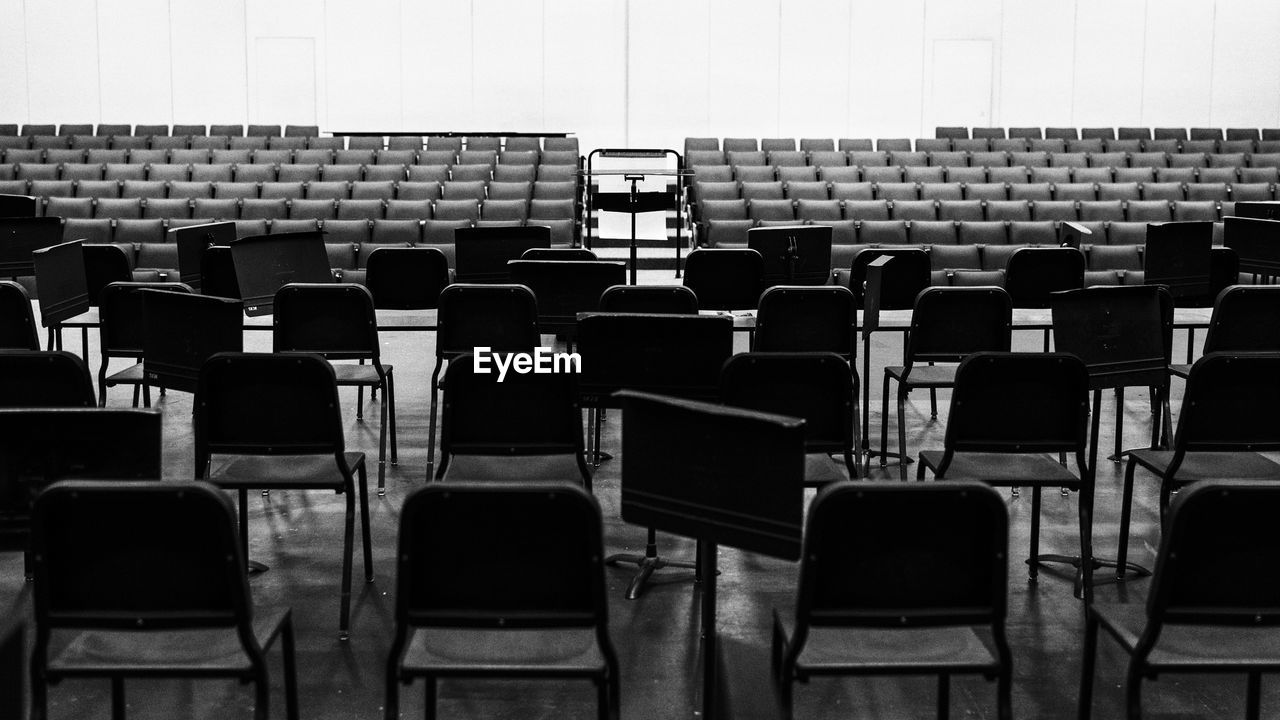 REAR VIEW OF EMPTY CHAIRS IN SHOPPING MALL