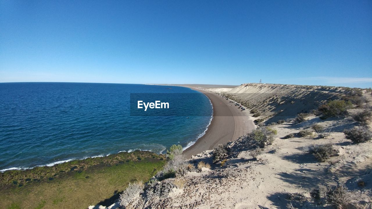 Scenic view of sea against clear blue sky