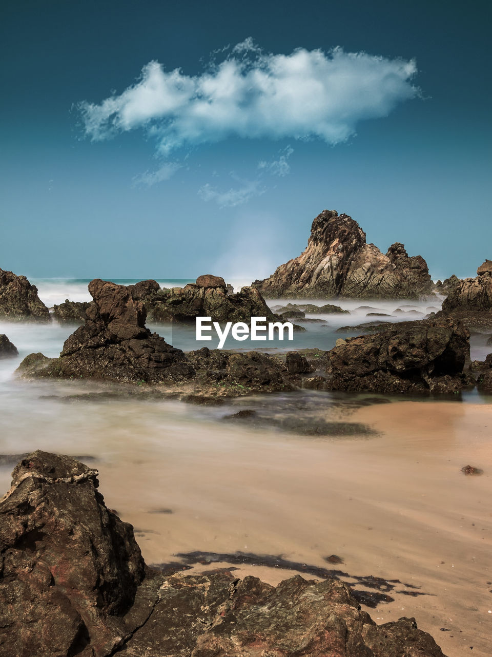 Rocks on beach against sky