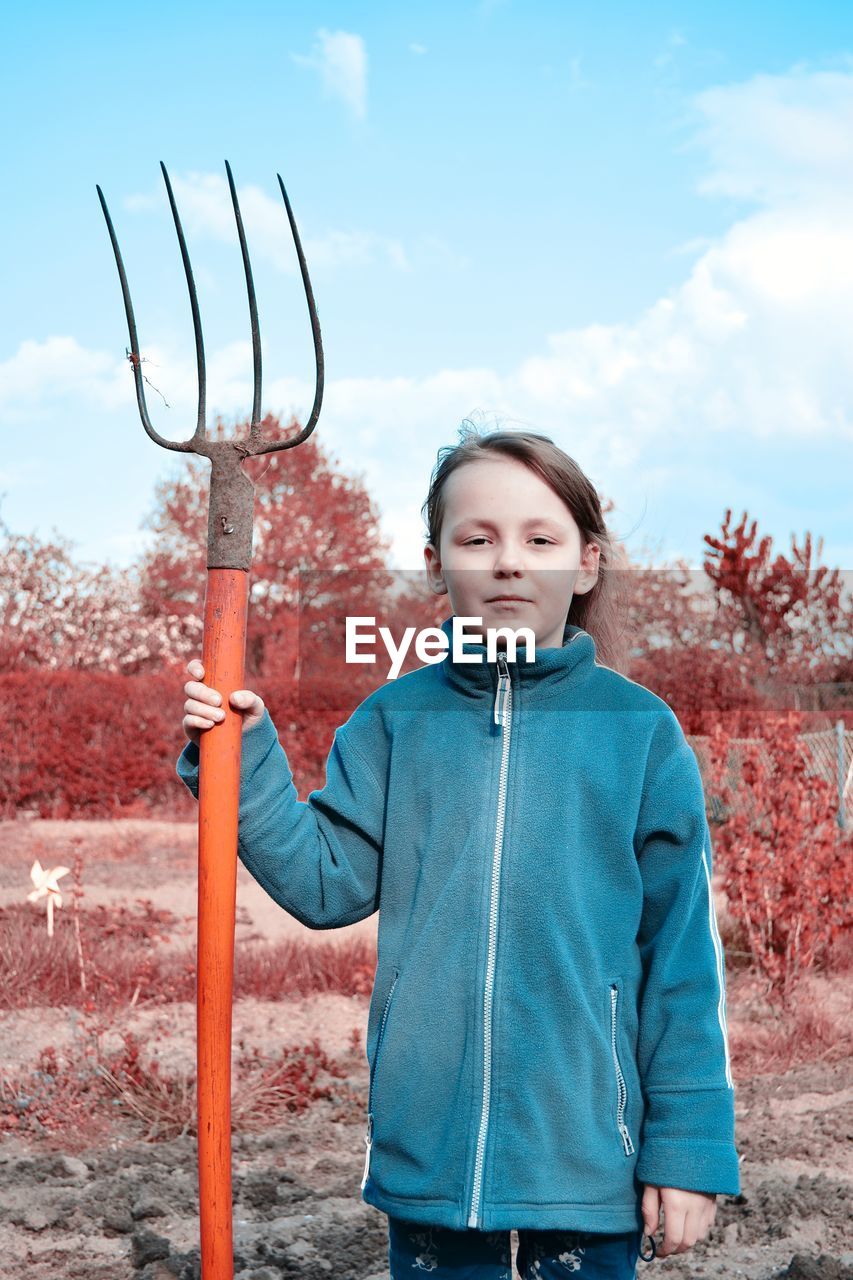 Portrait of young girl with pitchfork