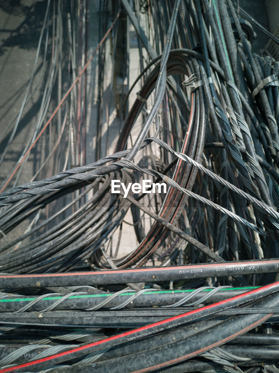 CLOSE-UP OF CABLES ON METALLIC WALL