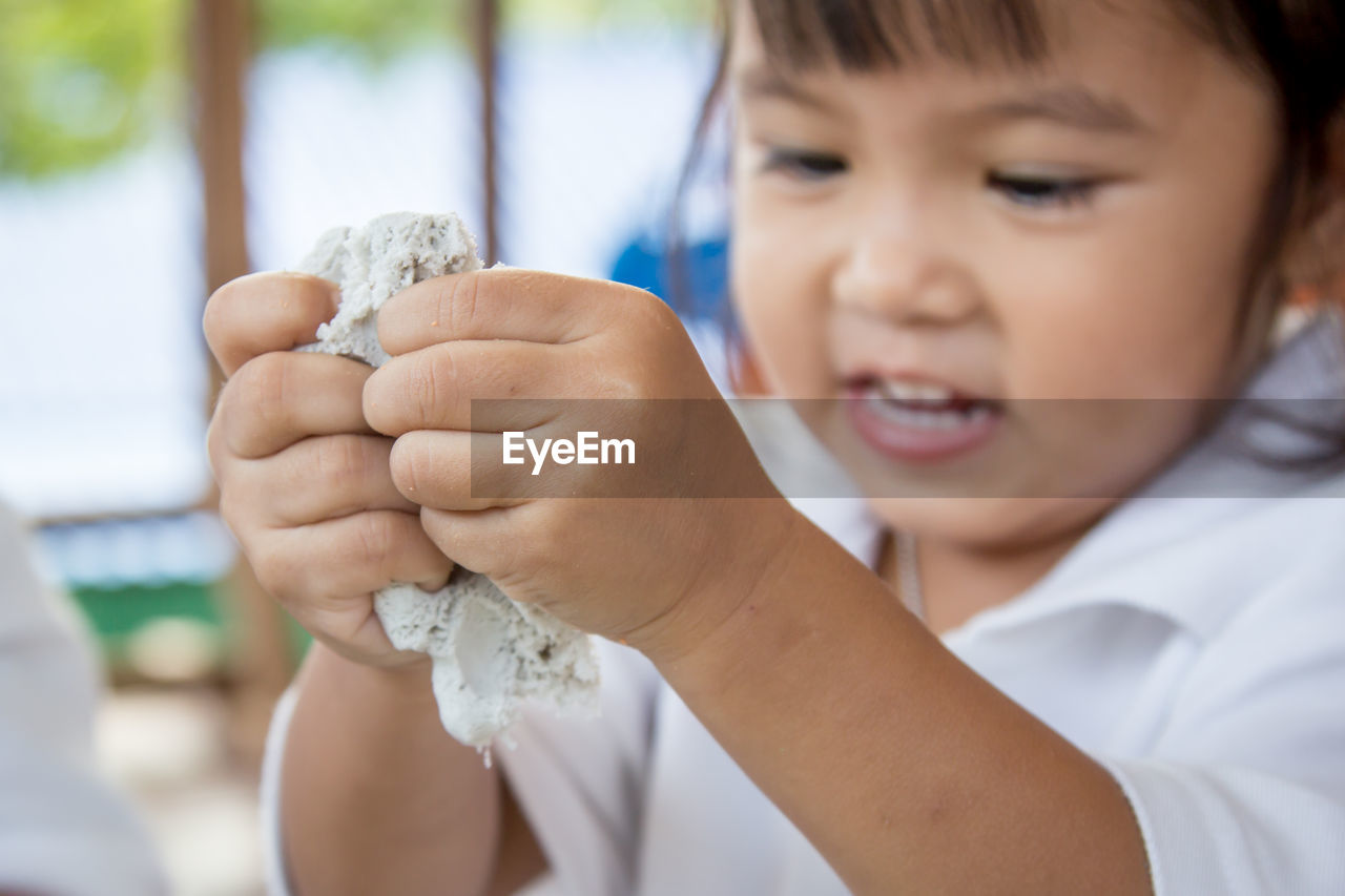 Close-up of girl playing with clay