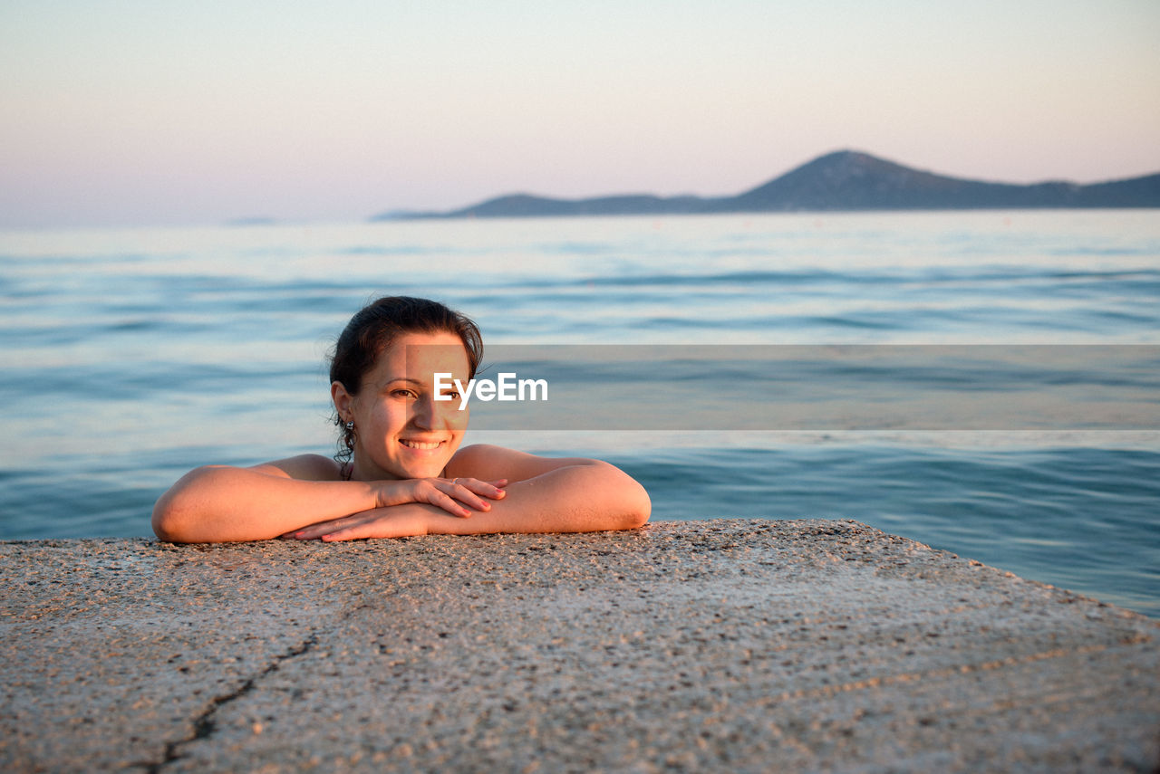 Happy woman swimming in sea