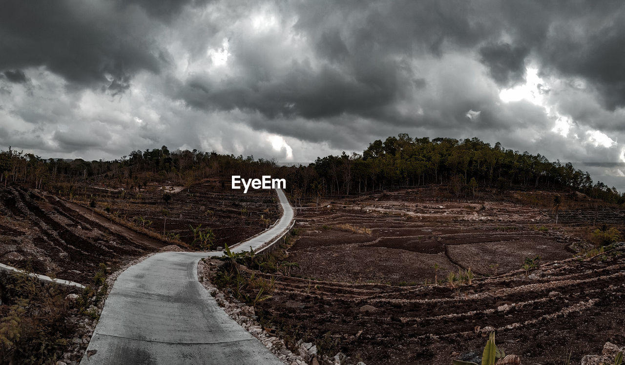 Panoramic view of road amidst landscape against sky